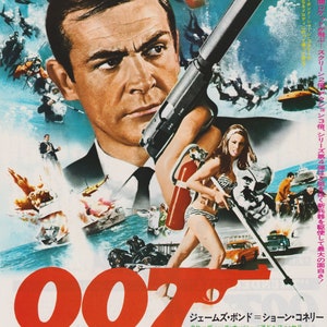 May include: A movie poster for the James Bond film "Thunderball" featuring Sean Connery as James Bond. The poster features a red, white, and blue color scheme with a large image of Sean Connery holding a gun. The text "007" is prominently displayed in red and black.