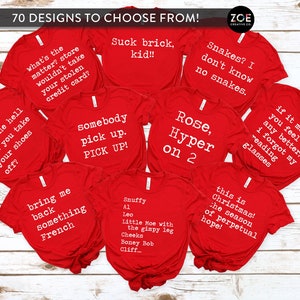 May include: A collection of red t-shirts with various funny sayings printed in white. The sayings include "Suck brick, kid!!", "Why the hell did you take your shoes off?", "What's the matter? Store wouldn't take your stolen credit card?", "Somebody pick up. PICK UP!", "Bring me back something French", "Snuffy A1 Leo Little Moe with the gimpy leg Cheeks Boney Bob Cliff", "Snakes? I don't know no snakes.", "Rose, Hyper on 2", "If it makes you feel any better, I forgot my reading glasses", and "This is Christmas! The season of perpetual hope!"