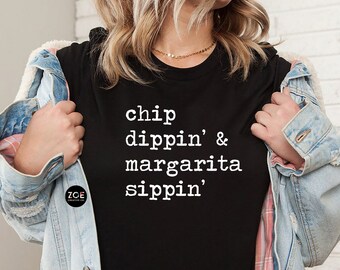 May include: Black t-shirt with white text that reads "chip dippin' & margarita sippin'".