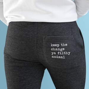 May include: Gray sweatpants with a white pocket on the back that says "keep the change ya filthy animal".