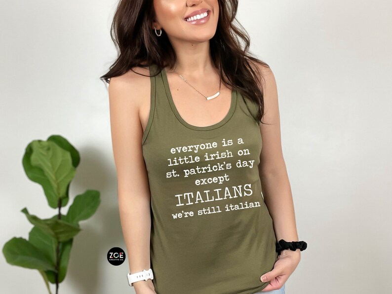 May include: Olive green tank top with white text that reads "everyone is a little irish on st. patrick's day except ITALIANS we're still italian". The tank top has a racerback style.