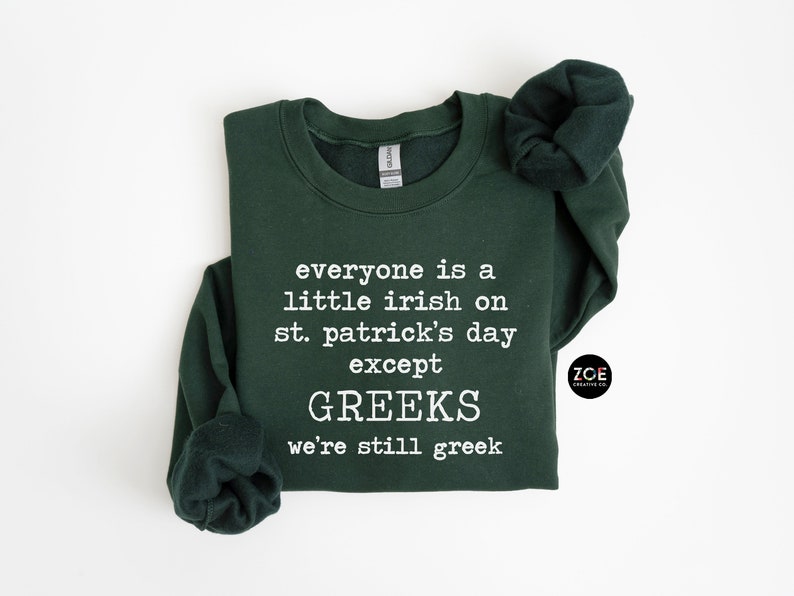May include: A dark green sweatshirt with the text "everyone is a little irish on st. patrick's day except GREEKS we're still greek" printed in white.