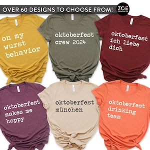 May include: Six different t-shirts with various Oktoberfest-themed designs printed in white text. The shirts are folded and displayed on a white background. The designs include "on my wurst behavior", "oktoberfest crew 2024", "oktoberfest ich liebe dich", "oktoberfest makes me hoppy", "oktoberfest münchen", and "oktoberfest drinking team".