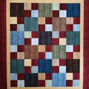 May include: A wooden square with a checkerboard pattern of different colored wood squares. The squares are in shades of brown, blue, green, and red.