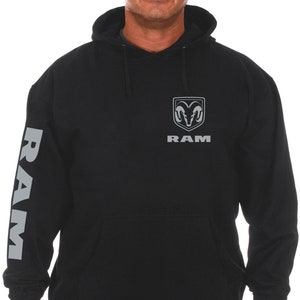 May include: Black hooded sweatshirt with a gray Ram logo on the front and the word "RAM" in gray lettering below the logo. The left sleeve has the word "RAM" in gray lettering.