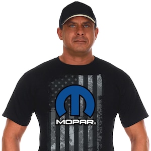 May include: Black t-shirt with a distressed American flag design featuring the blue Mopar logo and the word "MOPAR" in white text.