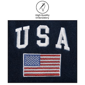 May include: Embroidered patch featuring the word "USA" in white block letters above a detailed American flag. The patch is on a navy blue background, with the text "High Quality Embroidery" above.