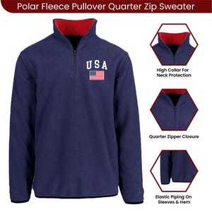 May include: Navy blue polar fleece quarter-zip sweater with a red collar lining. Features the text "USA" and an American flag patch. Includes a high collar for neck protection, quarter zipper closure, and elastic piping on sleeves and hem.