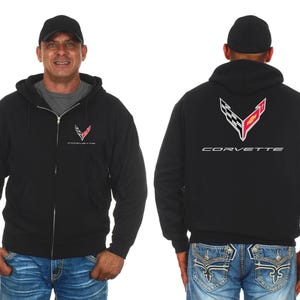 May include: Black zippered hoodie with a Corvette logo on the front and back. The logo features a red and white checkered flag and the word "Corvette" in silver lettering.