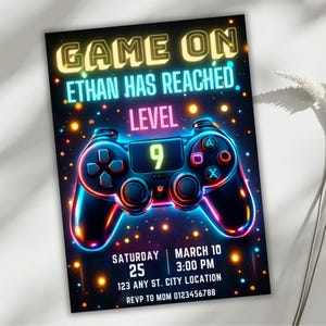 May include: A vibrant invitation with a gaming theme. The design features a neon-lit game controller and the text "GAME ON, ETHAN HAS REACHED LEVEL 9." Additional details include the date, time, and location for the event.