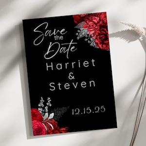 May include: Black save the date card with red and silver floral accents. The text reads "Save the Date" with the names Harriet & Steven and the date 12.15.25.