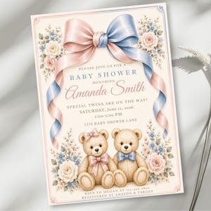 May include: A rectangular baby shower invitation card featuring a large pink and blue ribbon bow at the top, floral accents, and two teddy bears at the bottom. The text reads: Please join us for a baby shower honoring Amanda Smith, special twins are on the way, Saturday, June 15, 2026, 2:00-5:00 PM, 1234 Baby Shower Lane, registered at Amazon & Target.