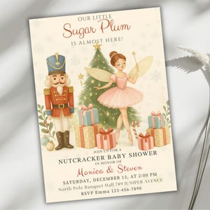 May include: A baby shower invitation with a whimsical Nutcracker theme. The design features a fairy, a nutcracker soldier, a Christmas tree, and wrapped gifts. The text reads "Our Little Sugar Plum Is Almost Here!" and includes event details.