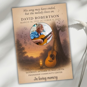 May include: A memorial card with a sepia-toned background features a photo of a man playing a guitar. Text includes the name "DAVID ROBERTSON" and dates. Musical notes and a guitar are also depicted. The text reads "His song may have ended, but the melody lives on."