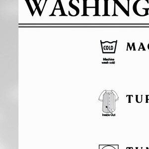 May include: White background with the text "WASHING INSTRUCTIONS" in black. Instructions include machine wash cold, turn item inside out, tumble dry on low, hang for best care, do not iron design, and do not use bleach.