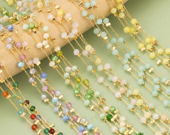 Puede incluir: Una variedad de cuentas de vidrio de colores enhebradas en una cadena dorada, creando una pieza de joyería delicada y elegante. Las cuentas son en tonos de azul, verde, amarillo, rosa y blanco.