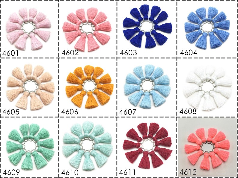 May include: Twelve sets of ten small, colorful tassels with metal rings. Each set is arranged in a circle on a white background. The colors include pink, peach, orange, blue, light blue, white, green, light green, burgundy, and coral.