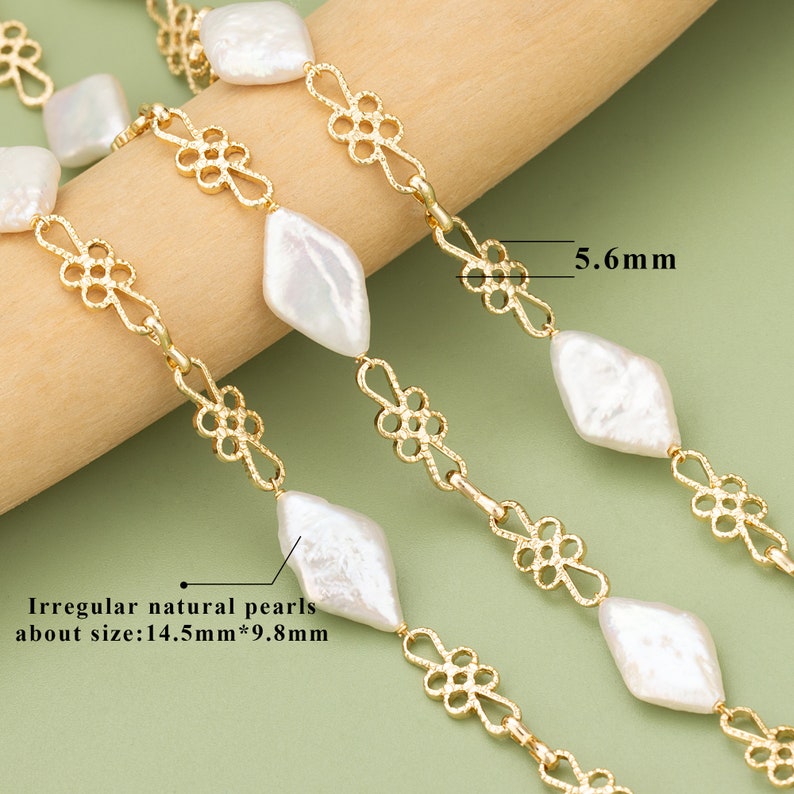 May include: A gold chain necklace with irregular natural white pearls. The pearls are approximately 14.5mm by 9.8mm. The chain features a delicate floral design. The chain is 5.6mm wide.
