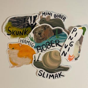 May include: A selection of animal stickers, including a skunk, hamster, beaver, snail, mouse, and penguin. Each sticker has the animal's name written on it. The stickers are colourful and have a white border.