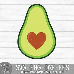 May include: A green avocado with a brown heart in the center. The avocado is on a white wood background.