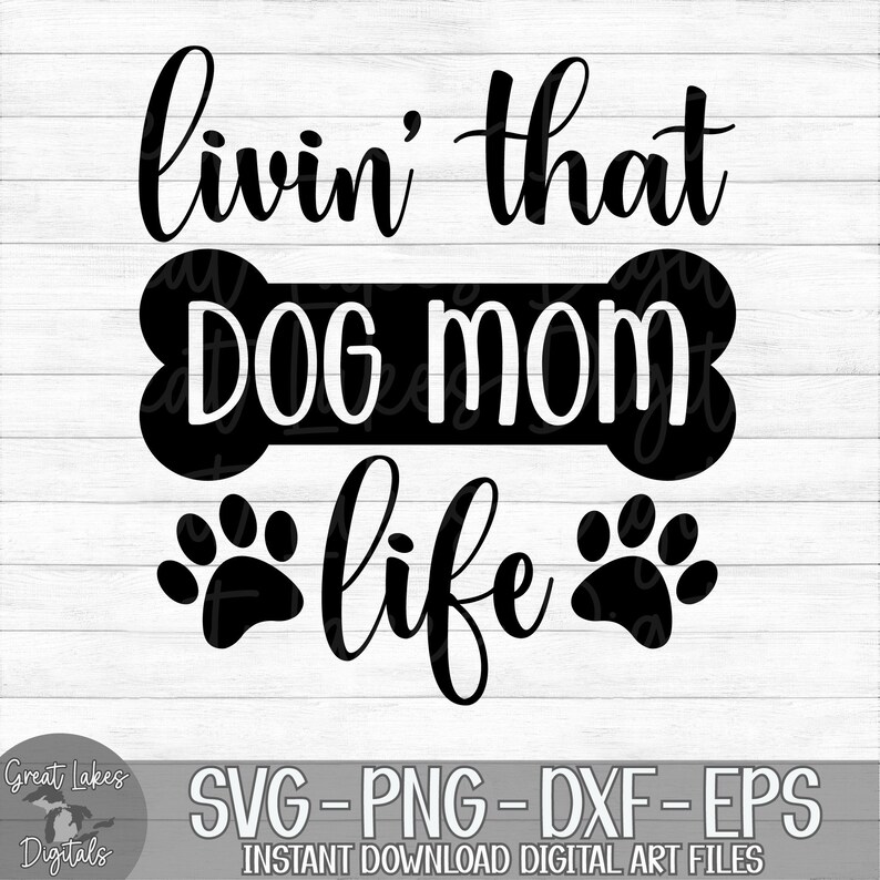 May include: Black and white graphic design with the text "livin' that DOG MOM life" with two paw prints on either side of the text.