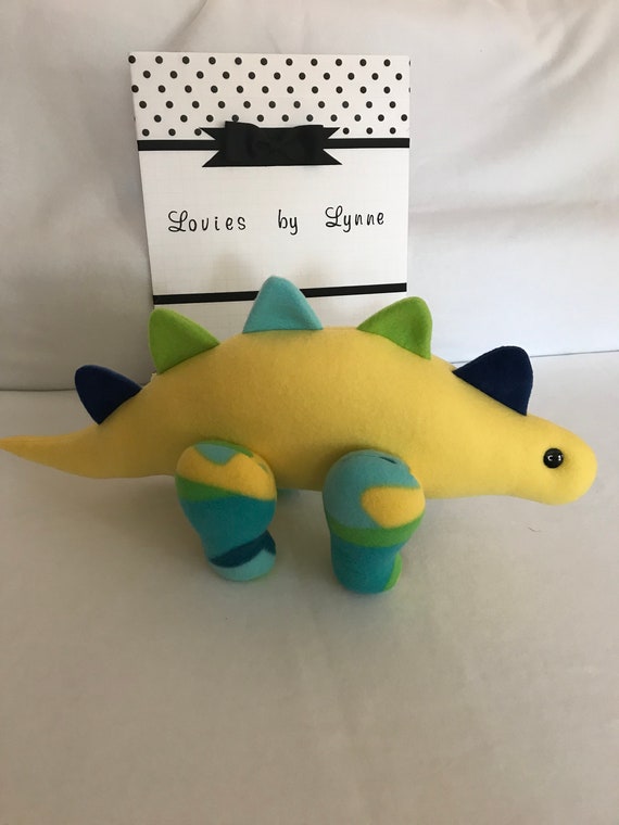 yellow stuffed dinosaur