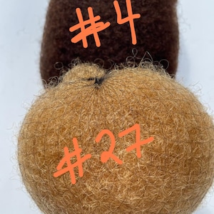 May include: Two brown and blonde hair pieces, one labeled #4 and the other #27.