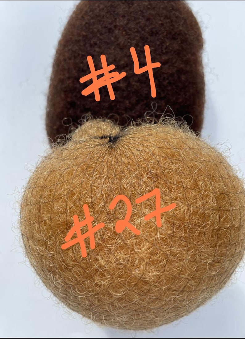 May include: Two brown and blonde hair pieces, one labeled #4 and the other #27.