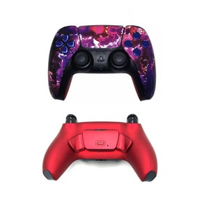 May include: Two different PlayStation 5 controllers. The top controller is black with a purple and pink marbled design. The bottom controller is red.