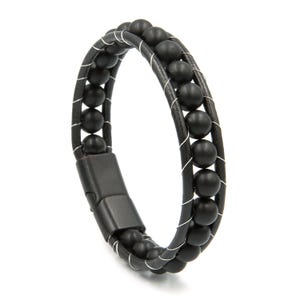 May include: A bracelet featuring two parallel black leather cords wrapped with thin silver-toned wire, interspersed with a single row of matte black spherical beads. The design includes a smooth, rectangular black metal clasp closure.