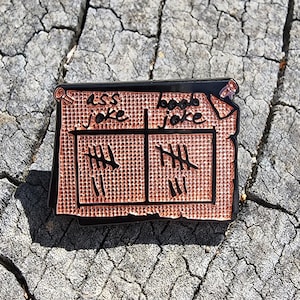 May include: Black and copper enamel pin with a jail cell design. The pin has two cells, each with the text "ass joke" and "boobs joke" and tally marks inside.