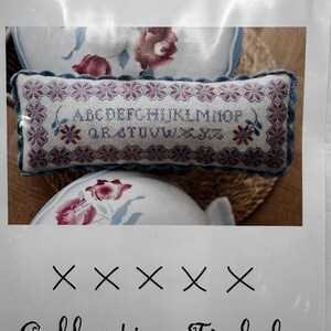 May include: A cross stitch sampler with the alphabet in red and blue on a white background. The sampler is titled "ABC rouge et bleu" and is part of the "Collection Tralala" series.