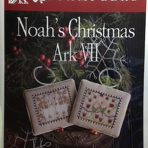 May include: A cross stitch pattern for a Christmas sampler featuring a llama and lovebirds. The pattern is titled "Noah's Christmas Ark VII" and is part of the Plum Street Samplers collection. The pattern is designed by Paulette Stewart.