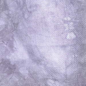 May include: Close-up of a piece of fabric with a cross-stitch pattern. The fabric has a tie-dye effect in shades of gray and white, creating a soft, textured appearance. The weave is visible, adding depth to the textile.