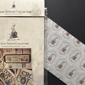 May include: A cross stitch kit featuring a rabbit and three signs with the text "I Cross Stitch Collector", "Stitch for", and "I Cross Collect".