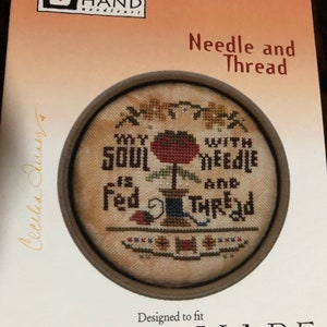 May include: A cross-stitch pattern for a round embroidery hoop with the text "My Soul is Fed with Needle and Thread". The pattern is designed to fit Heartware hoops.