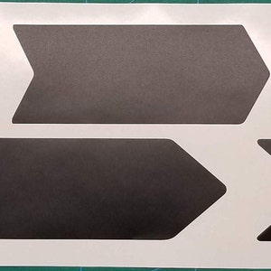 May include: A sheet of black vinyl stickers with arrow shapes. The stickers are designed to be applied to a bicycle frame.