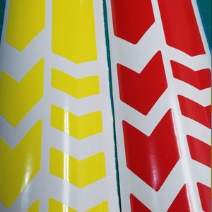 May include: Two sheets of white sticker paper with yellow and red chevron designs. The stickers are for decorating bikes.
