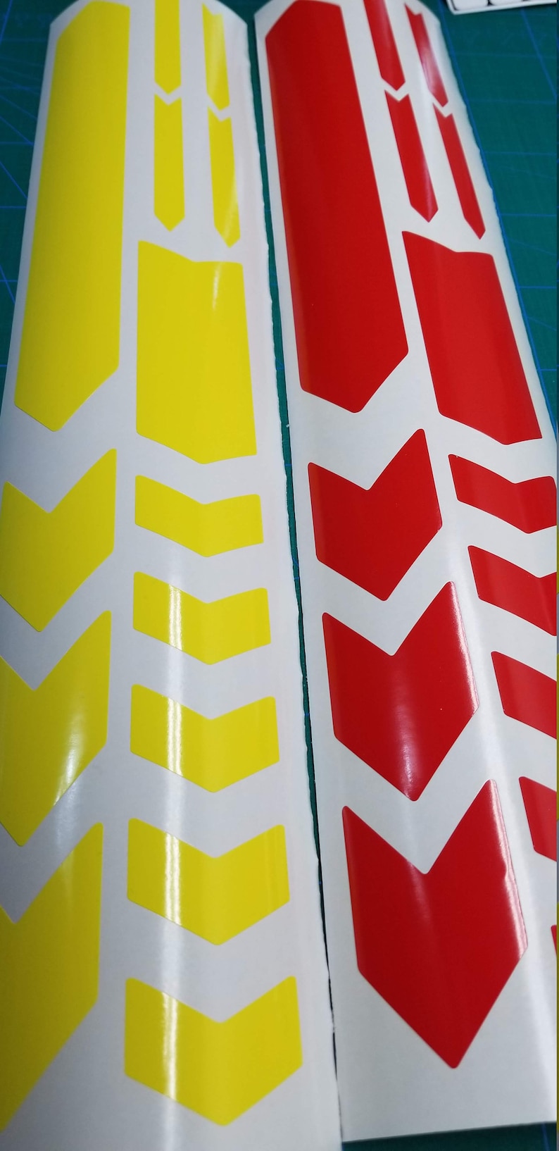 May include: Two sheets of white sticker paper with yellow and red chevron designs. The stickers are for decorating bikes.