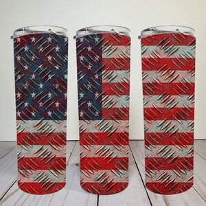 May include: Three stainless steel tumblers with a distressed American flag design. The flag is printed on a textured metal surface.