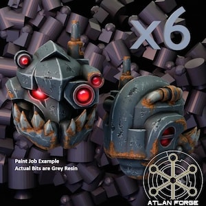 May include: A set of six grey resin miniature heads featuring a mechanical design with sharp teeth, multiple glowing red circular lenses, and weathered rust-colored details. The text reads Paint Job Example Actual Bits are Grey Resin and Atlan Forge.