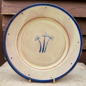 May include: A set of three ceramic mugs with a speckled, matte finish. The mugs are in shades of cream, light gray, and dark gray. Each mug has a simple, minimalist design, perfect for coffee or tea.