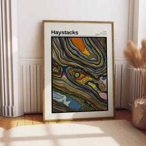 May include: A framed print of a colourful abstract design with the title "Haystacks" and location information: "1.7599° N, 3.2249° W, Lake District, 54.5686° N, 3.2289° W".