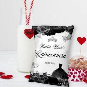 May include: A white favour bag with black and white butterflies and floral designs. The bag has the text "Amelia Marie's Quincea&ntilde;era" and the date "September 2nd, 2021".