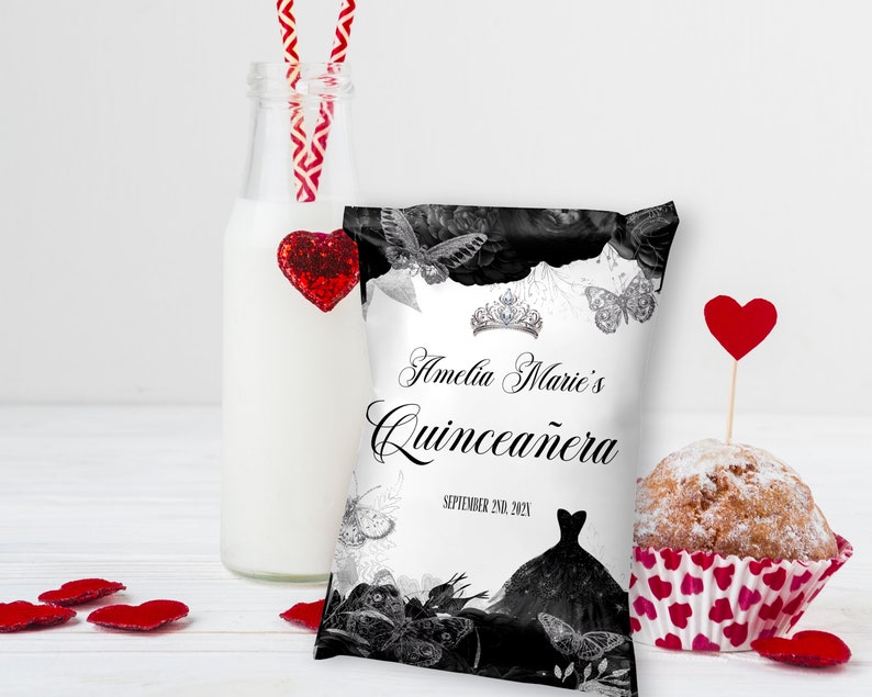 May include: A white favour bag with black and white butterflies and floral designs. The bag has the text "Amelia Marie's Quincea&ntilde;era" and the date "September 2nd, 2021".