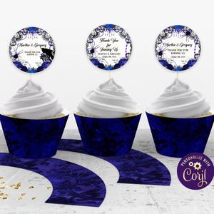 May include: Three cupcakes with white frosting and dark blue wrappers. Each cupcake has a circular topper with the text "Thank You for Joining Us" and the names "Martha & Gregory". The design includes spiderwebs and floral elements.