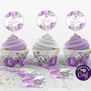 May include: Purple and gray cupcake wrappers with butterfly and floral designs. The wrappers are decorated with a personalized label that says "Gabriela's Quinceañera".