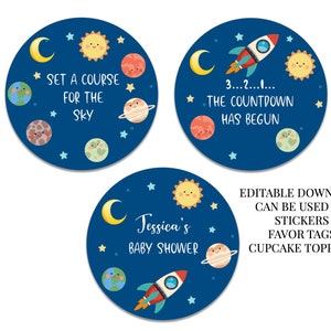 May include: Three blue and white circular stickers with a space theme. The stickers feature a rocket, planets, stars, and the text "Set a course for the sky", "3...2...1... The countdown has begun", and "Jessica's Baby Shower".