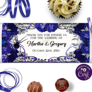 May include: Wedding favor chocolate bar wrapper with a black spider, blue roses, and silver glitter. The wrapper says "Thank you for joining us for the wedding of Martha & Gregory October 22nd, 202X".