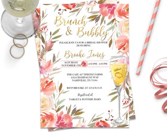 May include: A bridal shower invitation with the text "Brunch & Bubbly" in gold script, surrounded by watercolour floral arrangements in shades of pink and peach. A champagne glass with rings is featured. Includes event details.